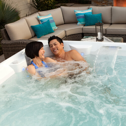 Couple test soaking in a hot tub service